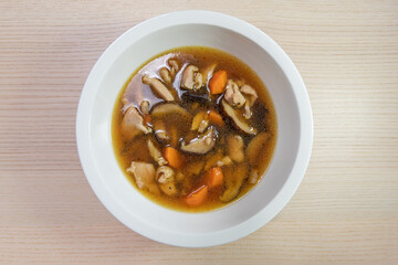 A bowl of chicken, carrot, and mushroom stew.