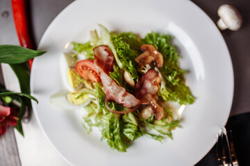 Light salad with vegetables bacon cherry grilled mushrooms tomatoes egg. delicious summer lunch