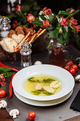 a white bowl filled with Delicious chicken noodle soup