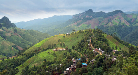 Obraz premium Mountain landscape, wooden house on a slope, on sky.