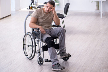 Fototapeta na wymiar Young leg injured man in wheel-chair