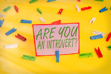 Writing note showing Are You An Introvertquestion. Business concept for an individual who tends to...