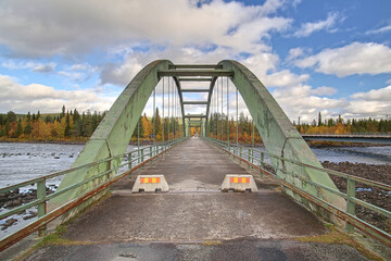 Old bridge crossing Pite river at Ljusselforsen in Lapland