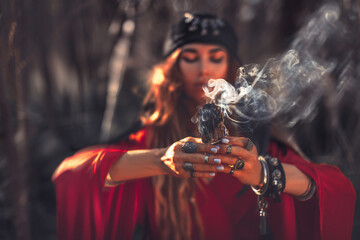 close up of woman hands with shamanic fire outdoors - 386085901
