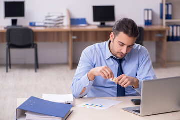 Sick male employee suffering at workplace