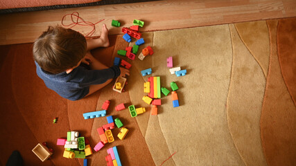 Child plays with toys, top view