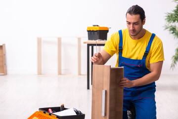 Young male carpenter working indoors