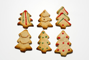Homemade Christmas gingerbread cookies isolated on white background. Pine-shaped cookies. Decorated Christmas cookies