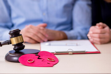 Young pair in courthouse in divorcing concept