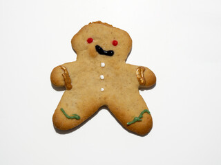 Homemade Christmas gingerbread cooky isolated on white background. Male or female cooky. Decorated Christmas cooky