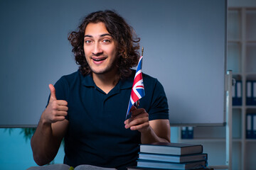 Young male student in the classroom at night