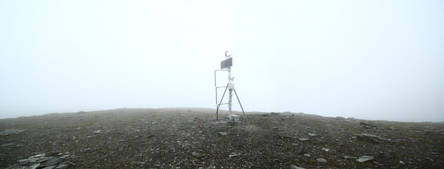 Measuring station in the fog on top of Mount Nuolja in Sweden
