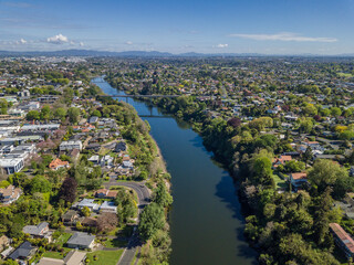 Aerial drone view looking at the Whitiora Bridge over the Waikato River as it cuts through the city of Hamilton, in the Waikato region of New Zealand