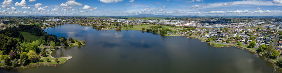 Fototapeta na wymiar Aerial drone panoramic view over Lake Rotoroa (Hamilton Lake) looking towards Mount Pirongia, Hamilton, in the Waikato region of New Zealand