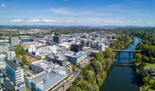 Aerial drone view looking at Claudelands Bridge over the Waikato River as it cuts through the city of Hamilton, in the Waikato region of New Zealand