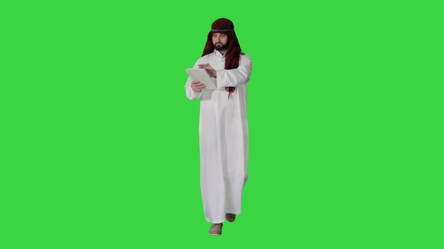 Sheikh presenting information or product using digital tablet on a Green Screen, Chroma Key.
