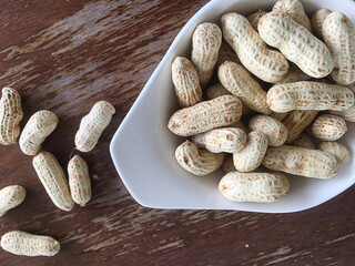 Dried peanuts on wooden table