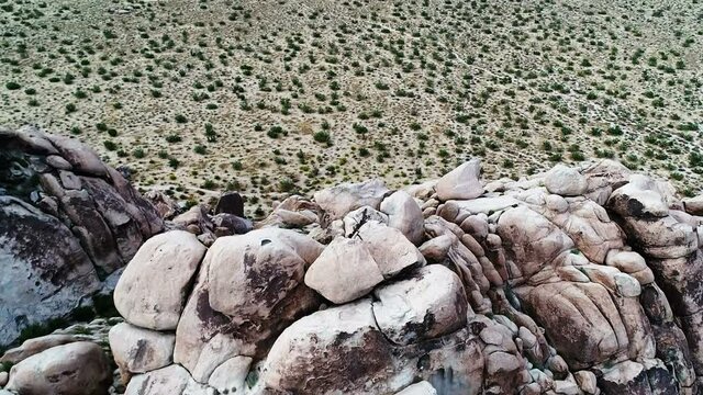 Drone tilt down view of unique Joshua Tree rock formations