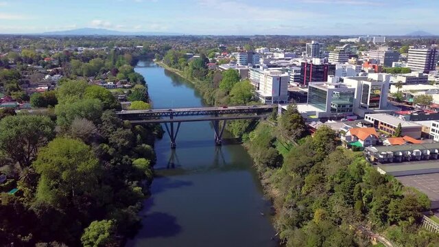 Aerial drone footage panning across the Waikato River and CBD over Hamilton City in the Waikato region of New Zealand (Aotearoa)