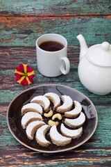 Putri Salju Kacang Mede or crescent-shaped cookies with cashew coated with powdered sugar. Popular Indonesian dessert to celebrate Eid al Fitr or Idul Fitri