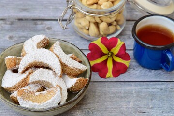 Putri Salju Kacang Mede or crescent-shaped cookies with cashew coated with powdered sugar. Popular Indonesian dessert to celebrate Eid al Fitr or Idul Fitri