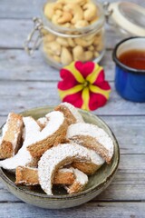 Putri Salju Kacang Mede or crescent-shaped cookies with cashew coated with powdered sugar. Popular Indonesian dessert to celebrate Eid al Fitr or Idul Fitri