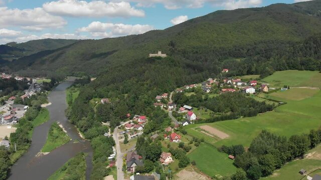 Village Sucha Struga and medieval castle in summer. Beskid Sadecki, Poland.
