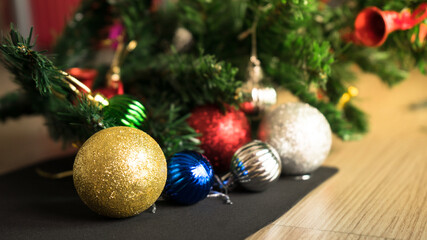 Horizontal image close up and selective focus red wrinkle Christmas ball hanging on Christmas tree for celebrate