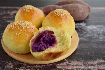 Sesame seed bread buns filled with purple sweet potato / yam puree
