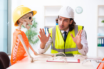 Funny construction business meeting with boss and skeletons