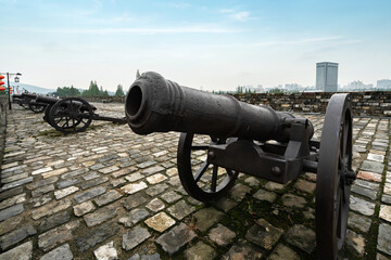 The ancient cannon is on the wall