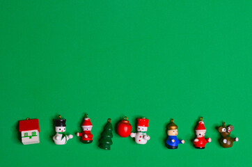 Christmas background wooden toys on green background copy space text top view