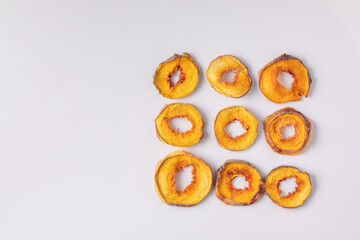 slices of dried peach on a white background. dried fruits. eco. top view.