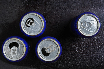 Beer cans in drops of water