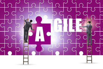 Agile concept with businessman putting jigsaw puzzle together