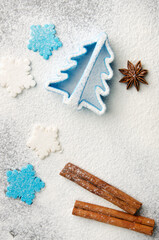Obraz na płótnie Canvas Christmas kitchen background made of flour, cinnamon sticks, anise, cookie cutter and sugar sprinkles