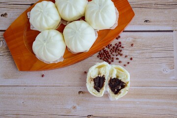 Asian steamed bun with red bean paste filling or Bakpao