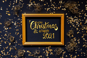 Frame With English Text Merry Christmas And A Happy 2021. Golden Christmas Decoration And Ornament. Black Background With Glitter And Sparkle