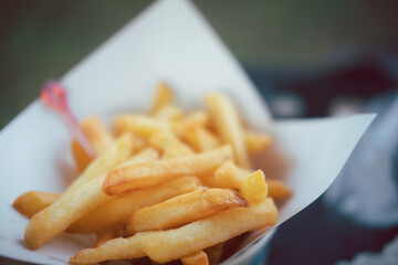 A paper bowl of french fries