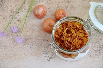 Indonesian crispy deep fried shallots or onion flakes (bawang goreng) in a jar