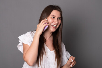 Fototapeta premium Happy young woman emotionally talking on a mobile phone.