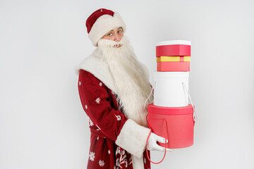 Santa Claus holds gifts in his hands. Isolated on white