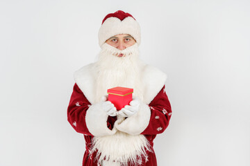 Santa Claus holds gifts in his hands. Isolated on white