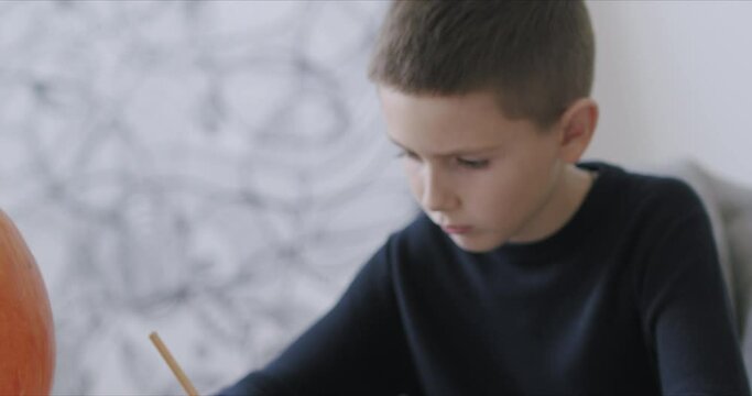 Kid drawing with pencils during quarantine at home