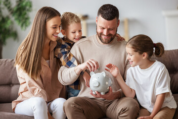 Happy family saving money together. - 386105133
