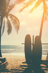 Surfboards beside coconut trees at summer beach. - obrazy, fototapety, plakaty