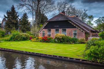 Dutch house and beautiful ornamental garden in Giethoorn village, Netherlands