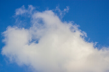 Naklejka na ściany i meble Soft white clouds and blue sky background.