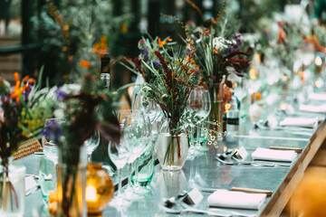Stylish Outdoor Dinner Party. Decorated  Table with beautiful wild flower bouquets.