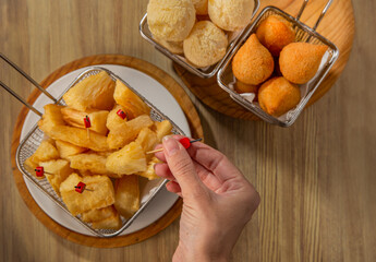 typical Brazilian food, fried cassava, cheese bread, snacks, guarana, beer
